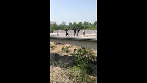 Fight result in man getting thrown off bridge. He survived hurt but alive.