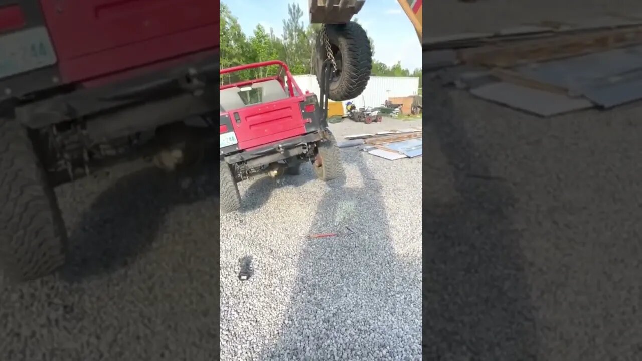 Sany excavator meticulously removing spare tire carrier form Jeep YJ