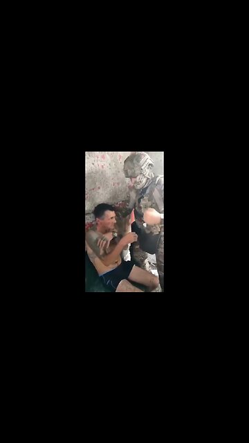 Russian soldier slapping captured Ukrainian soldier with nazi tattoos