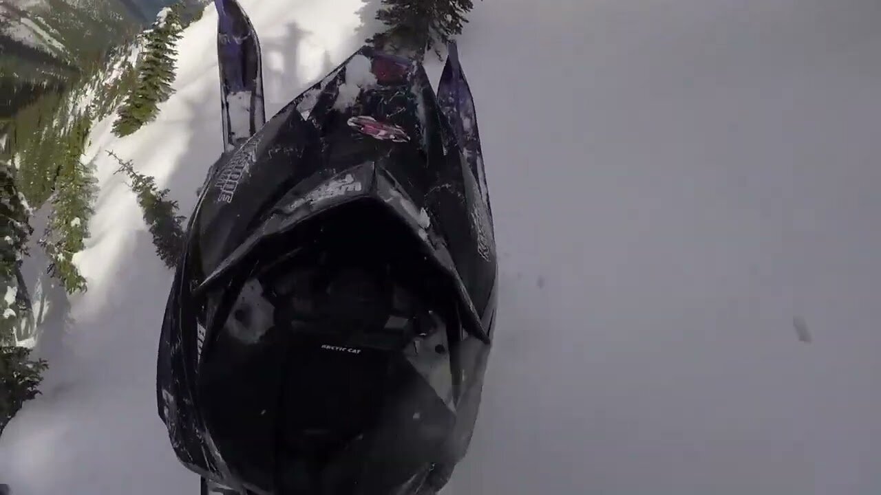 Dude tries to snowmobile up mountain, instantly regrets it