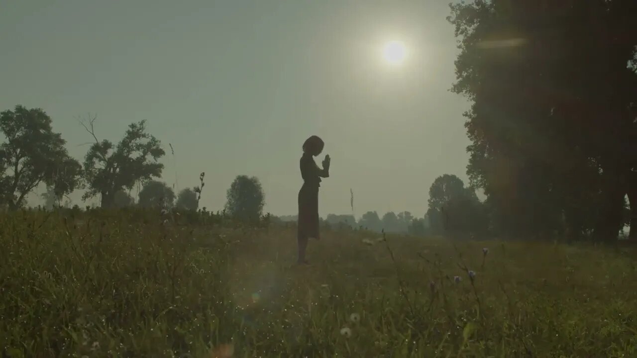 faithful female in sundress standing on green field saying prayers to god asking fo SBV 347125011 HD