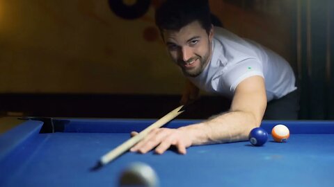 absorbed man playing snooker and smiling to the camera SBV 311066043 HD