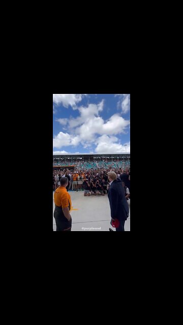 The Crowd chants "USA" as President Trump arrives at the McLaren Garage on Pit Lane