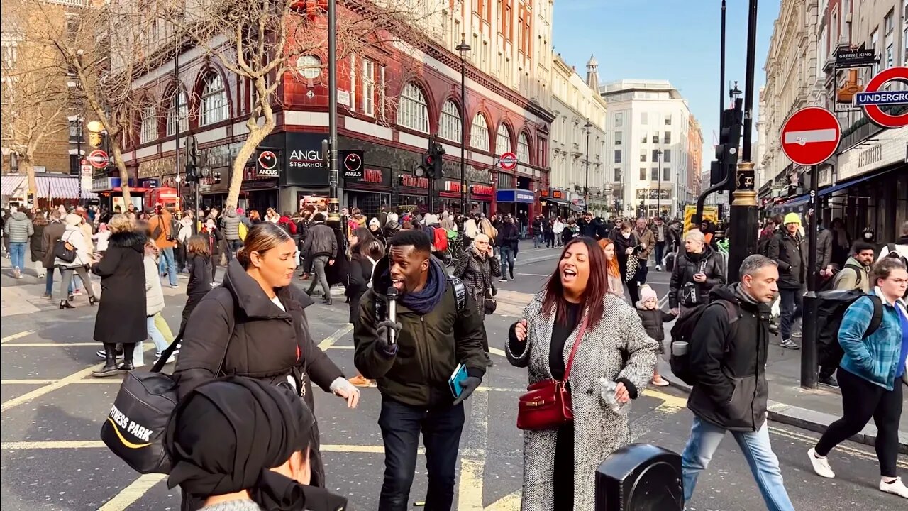 Enthusiastic preacher sings and dances for a crowd in London.