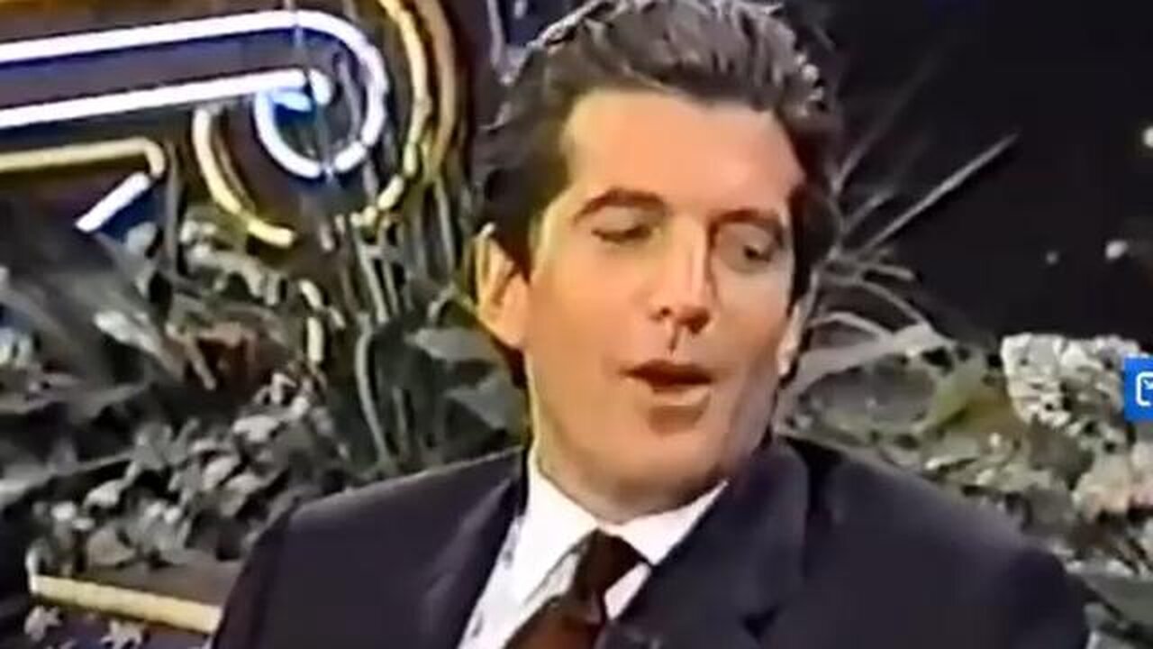 JFK Jr. reads a poem written by Monica Lewinsky, where she creatively describes herself as a PIZZA