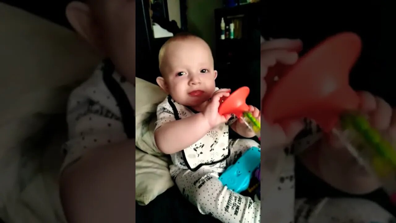 Cute Baby Boy Playing With Toy Whistle