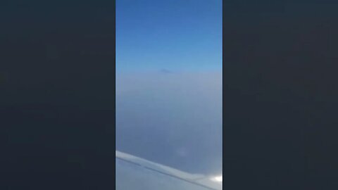 Beautiful! Flying past Mount Teide peeking out through the clouds!