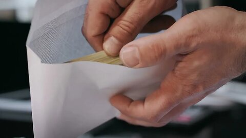 homem segurando envelope com conceito de suborno de notas de dólar bônus de dinheiro em papel