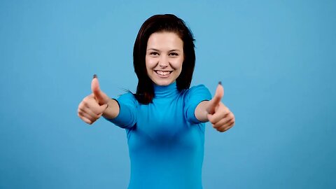 positive joyful cheerful woman showing thumbs up on blue background in studio prett SBV 325321836 HD