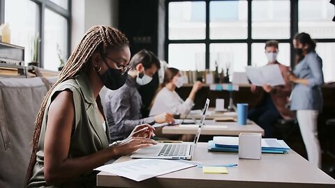 portrait of young businesspeople with face masks working indoors in office working SBV 338667935 HD