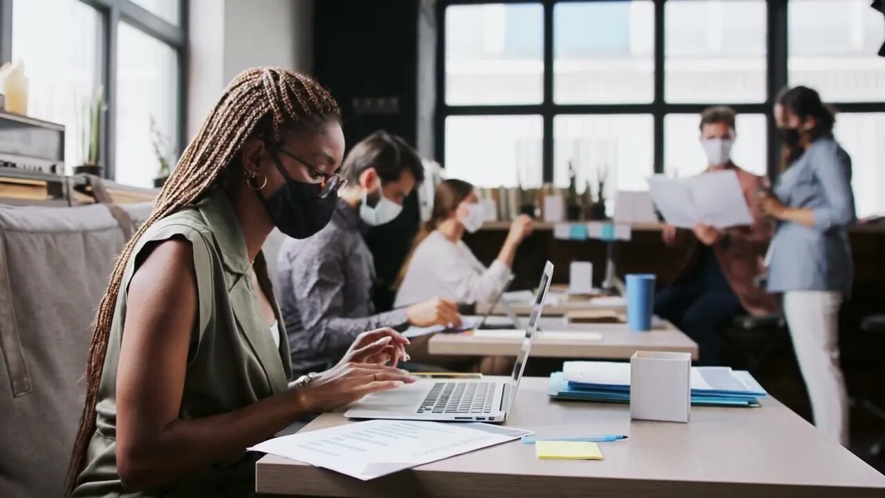 portrait of young businesspeople with face masks working indoors in office working SBV 338667935 HD