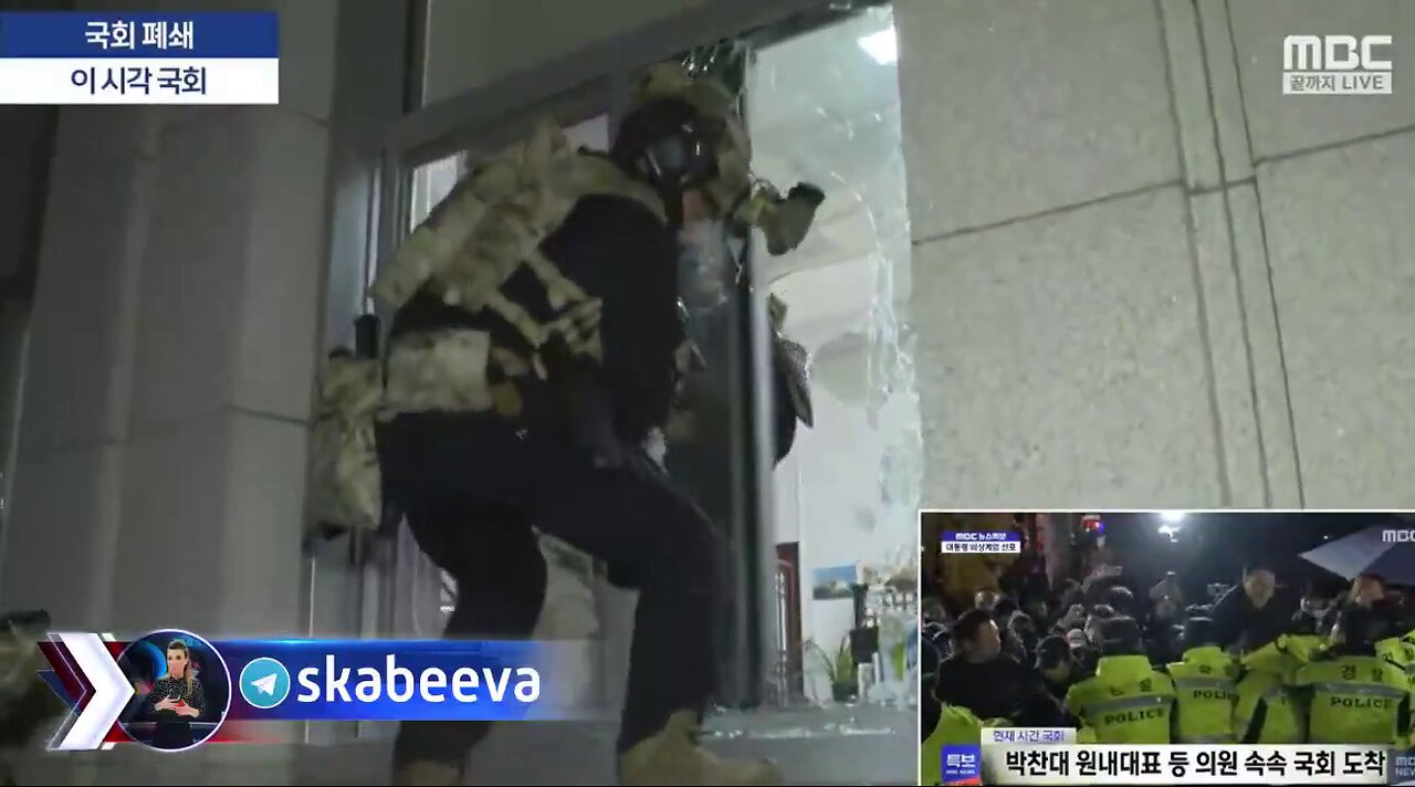 South Korean special forces break into the parliament building & arrest lawmakers under martial law.