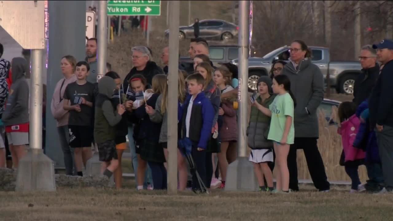 People pay respect to fallen officer on procession route