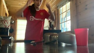 Practicing trick shots with kitchen pans