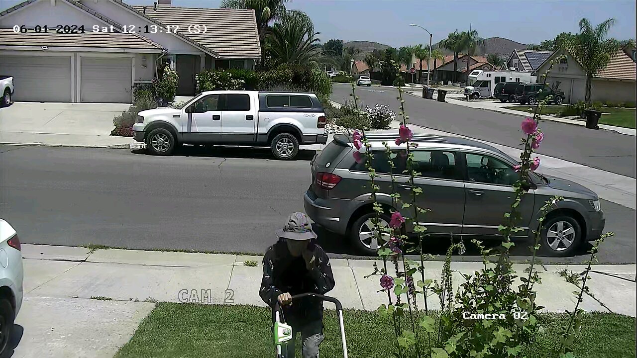 my wife mowing the grass