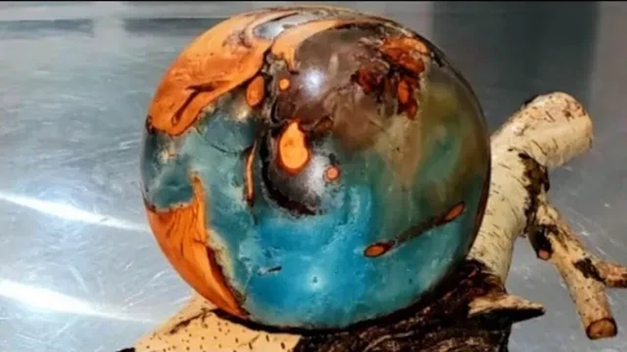 "Our Precarious World" Resin, Willow wood sphere on Birch lathe turned. O.U.R. at ArtForOUR.org