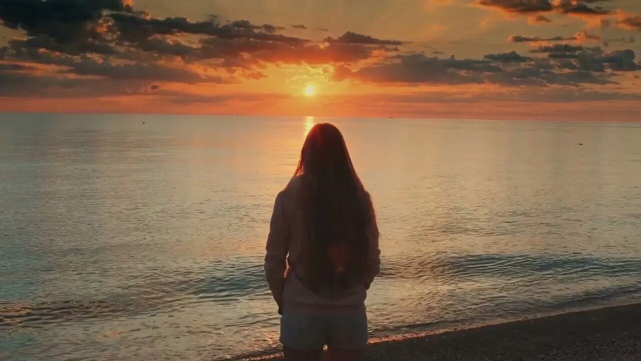 admiring sunrise on seashore woman raising up her hands back view SBV 338798006 HD