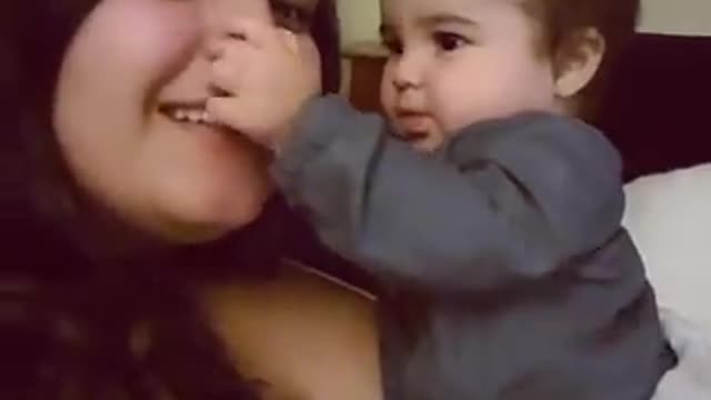 Baby kisses her mother funny