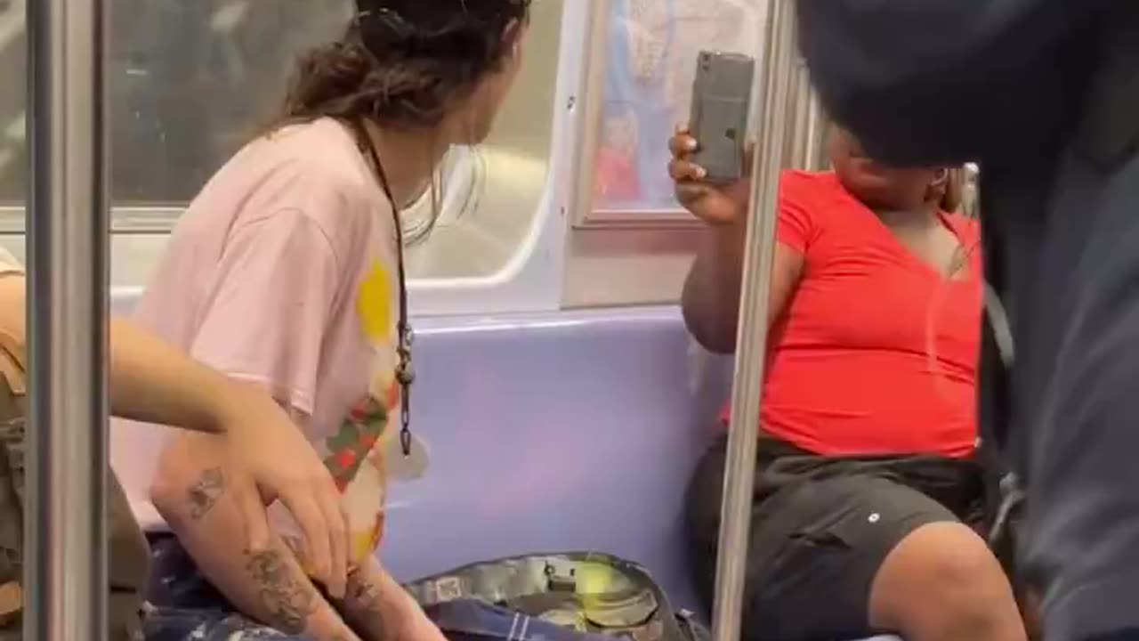 Woman gives unhinged trans activist a reality check on the New York metro.