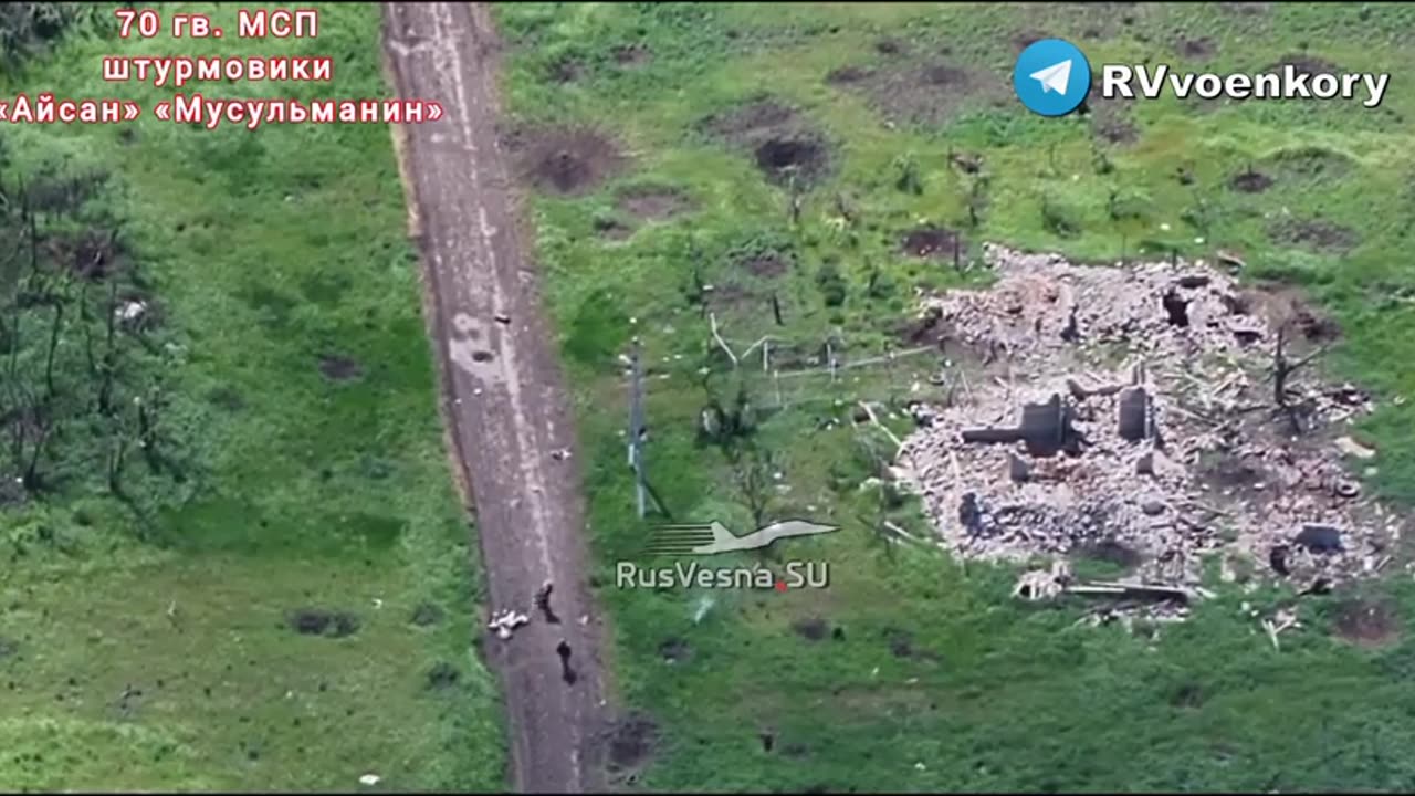 Two Russian soldiers on a motorbike "run the gauntlet" on the road into Robotyne