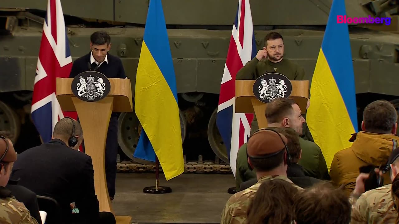 Ukrainian President Volodymyr Zelenskiy hugs a reporter during a press conference