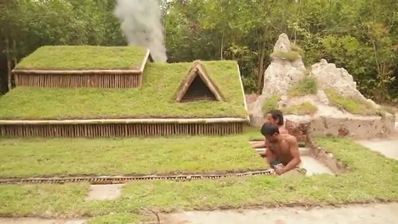 Building underground hut with grass roof & fireplace with clay