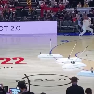 Robot mops attract attention at NBA game in Japan.