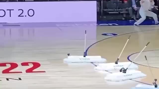 Robot mops attract attention at NBA game in Japan.