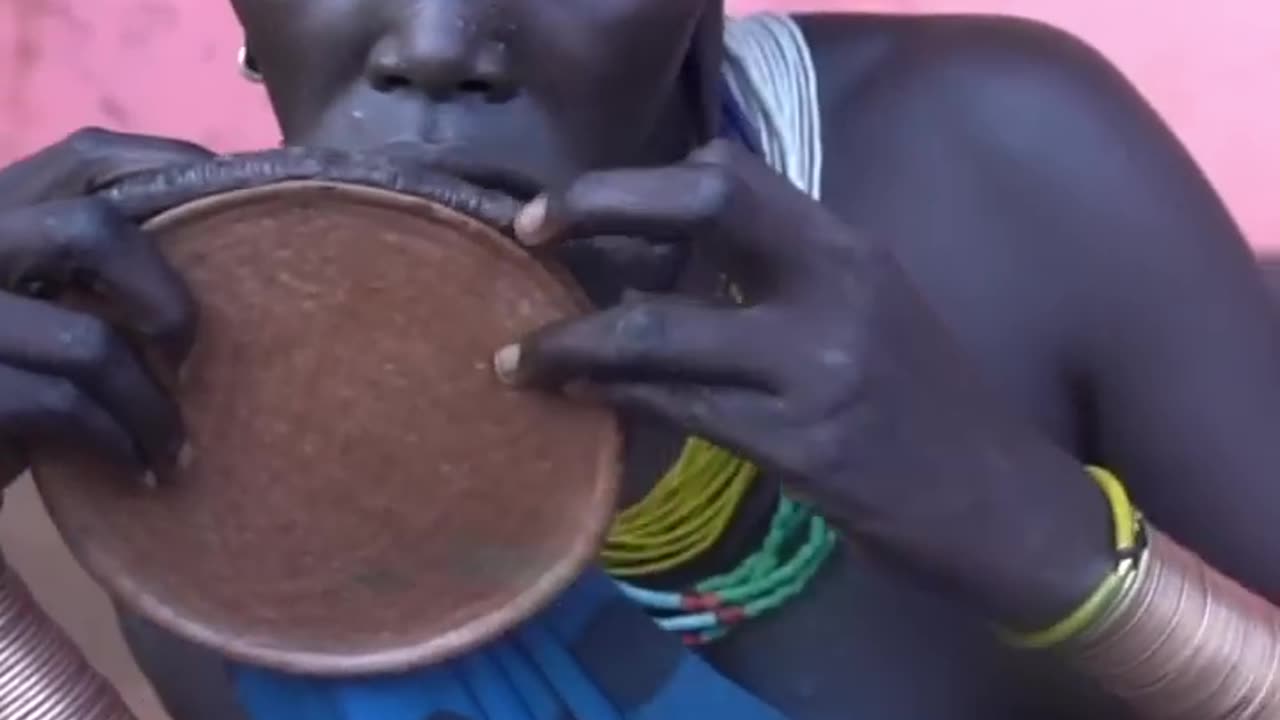 Woman from Surma Tribe Inserts Lip Plate | Omo Valley, Ethiopia