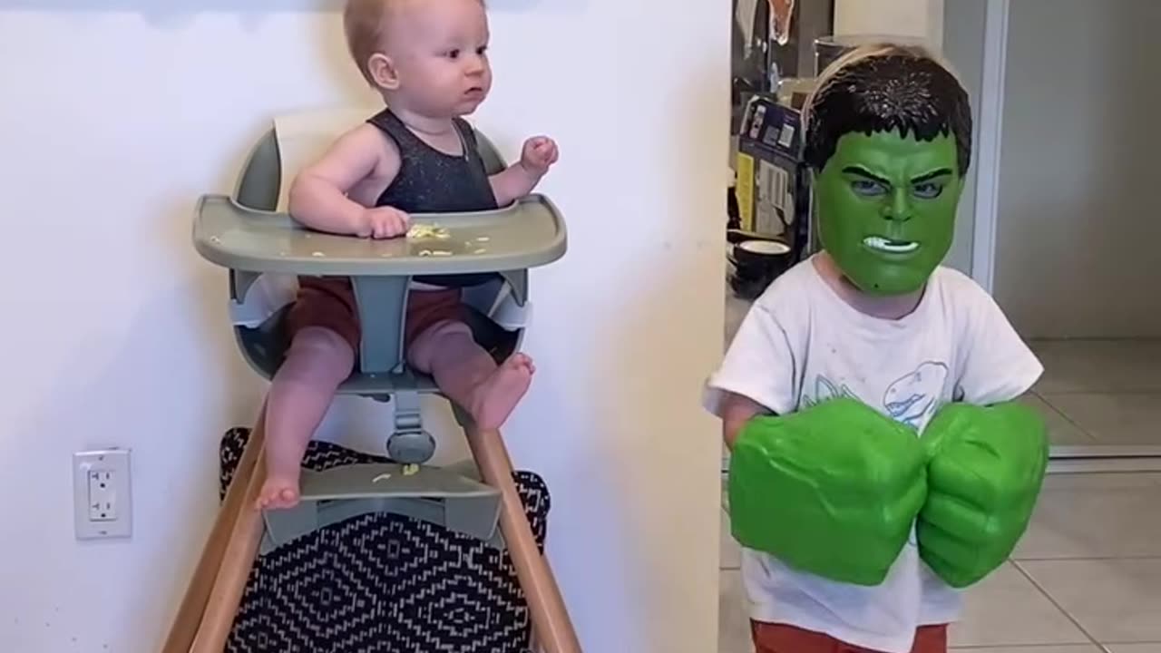 This naughty Canadian boy wore the mask of the green man and scared his infant brother