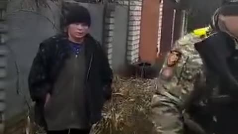 Ukrainian Soldiers near the front , picking on a woman