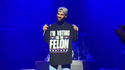 Dylan Scott holds up “I’m voting for the Felon” shirt at a concert & the crowd...