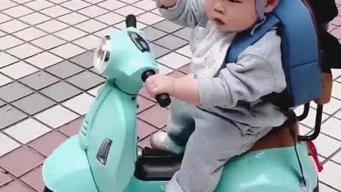 Small baby driving Scooter