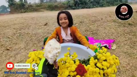 A sweet child selling lots of flowers