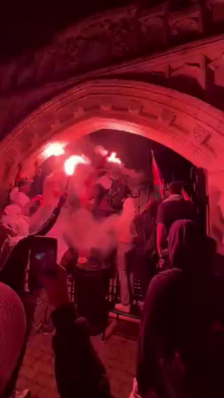 Protesters are trying to outnumber the police by using a combination of people and flares.