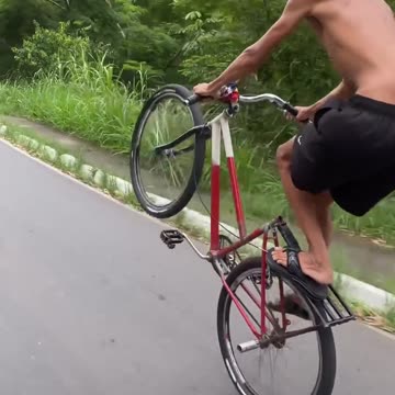 One wheeling bicycle on the road