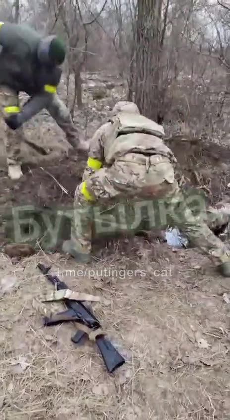 Ukrainian soldiers burying one of their own alive