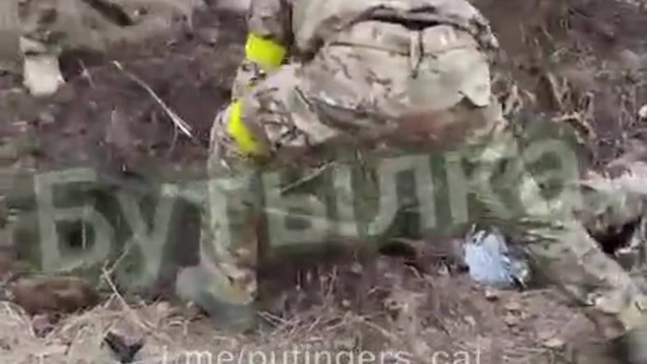 Ukrainian soldiers burying one of their own alive