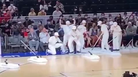 Robot mops attract attention at NBA game in Japan.