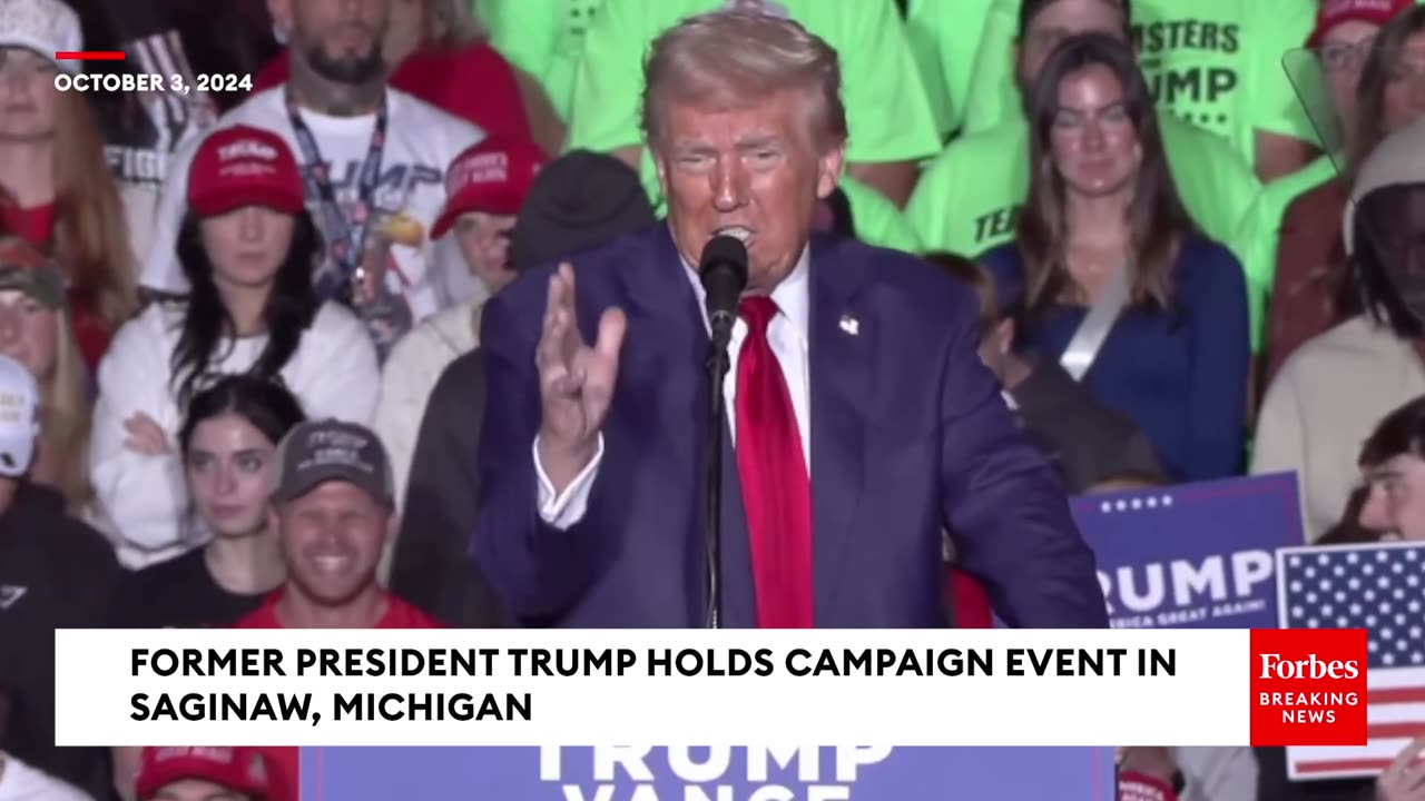 JUST IN- Trump Plays Video On Big Screen For Michigan Rally Crowd To Hammer Kamala Harris On Taxes