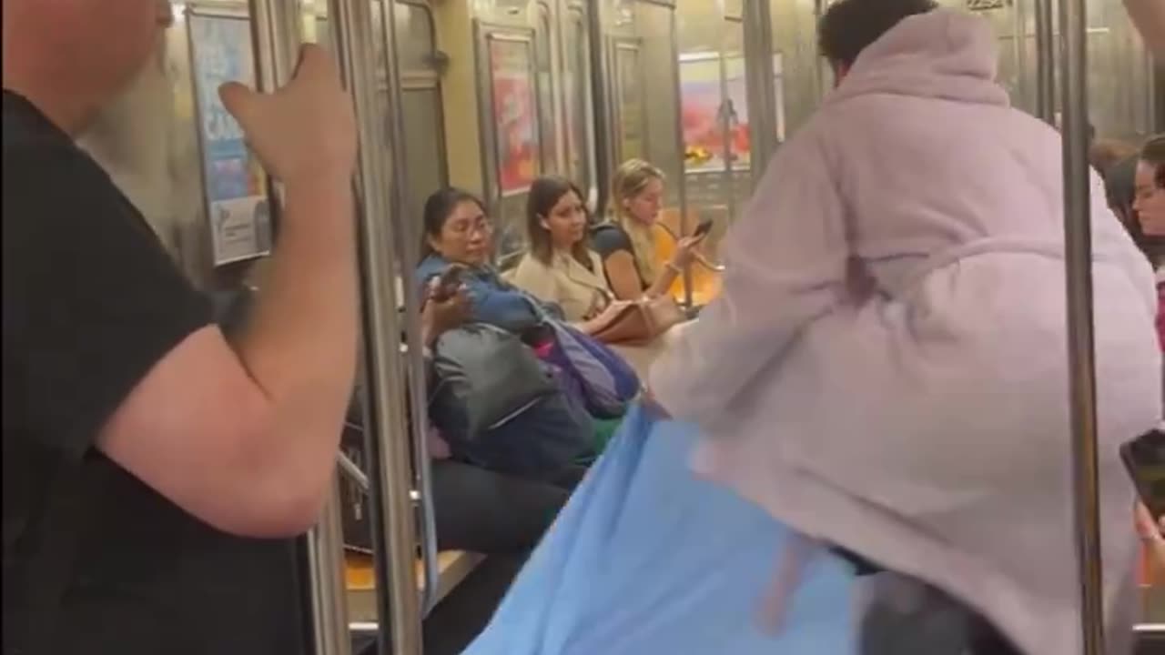 A man slept in a bed on the New York subway.