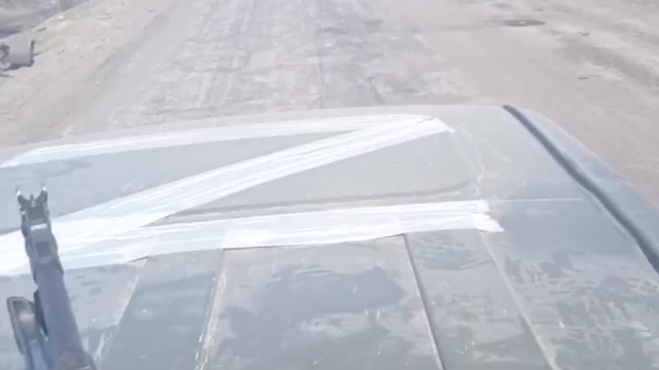 Russians driving past destroyed Ukrainian convoy