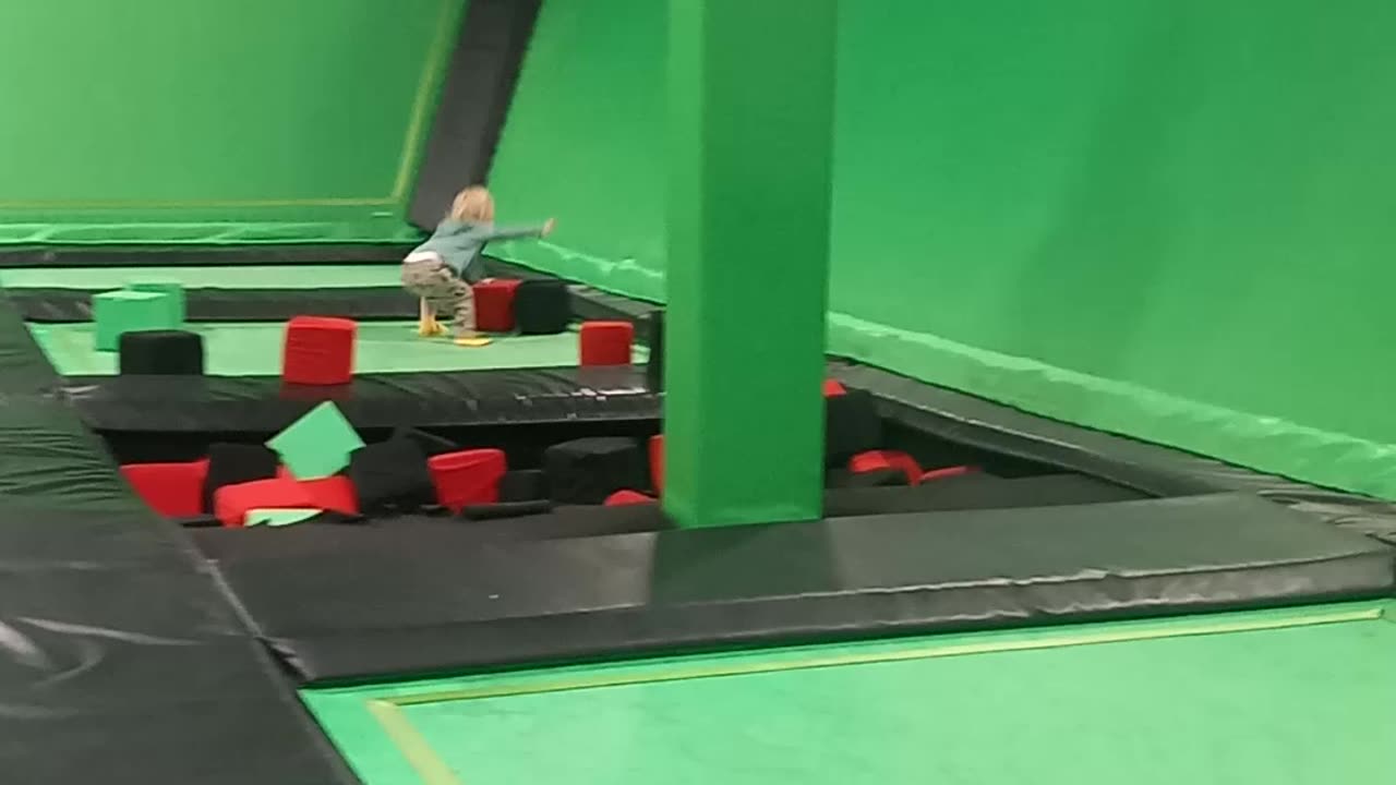 Fletcher throwing blocks on trampoline