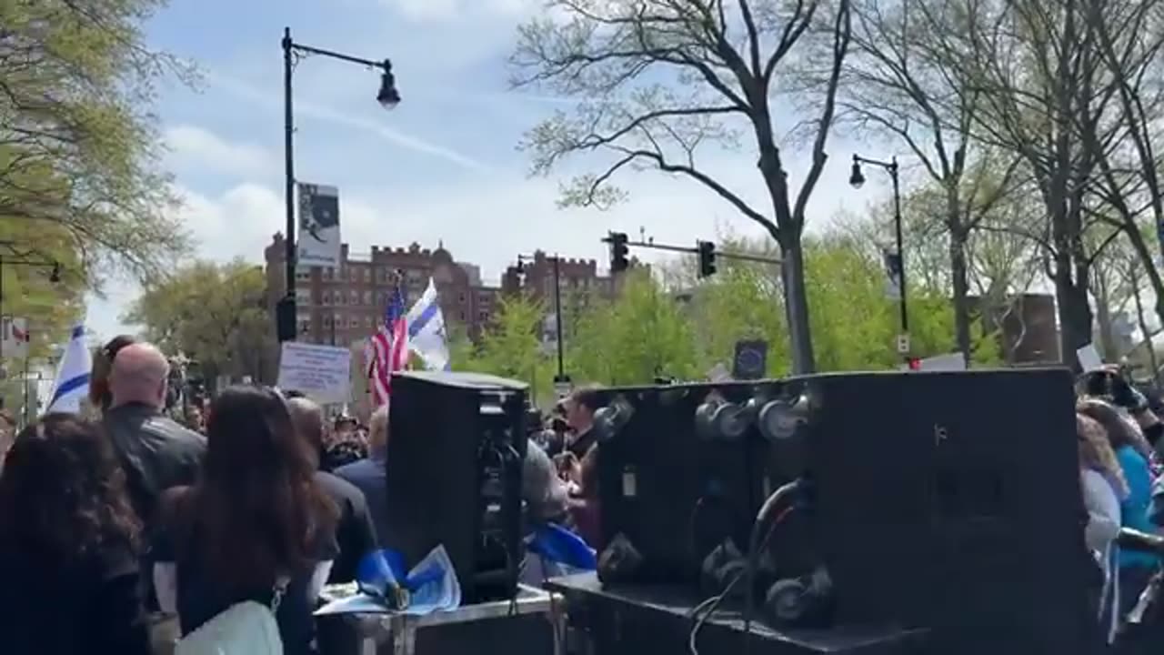 A dog sings the American National Anthem while participating in a patriotic protest at MIT