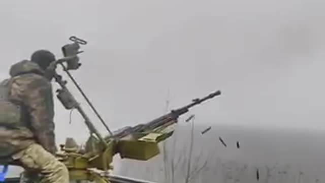 Ukrainian soldiers fire at a drone.