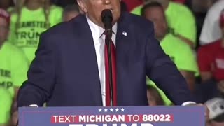 Man In Red Shirt Behind Trump at Rally Acts Strangely, Makes Hand Signals