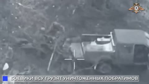 After Russian artillery strikes , Ukrainian troops seen loading the deceased into a truck