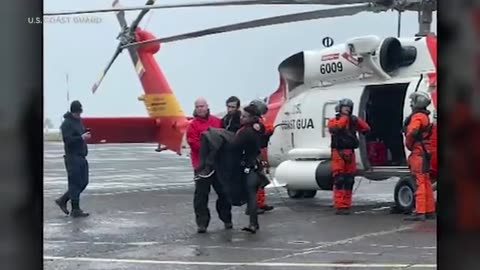 The Coast Guard rescued a man from a stolen yacht as it capsized in rough seas.