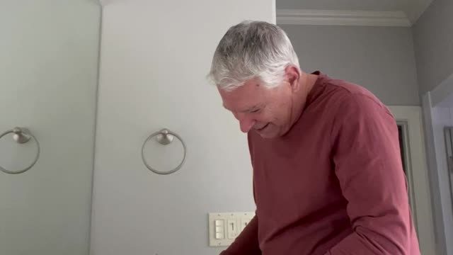 Pampered Raccoon Gets a Massage from Dad