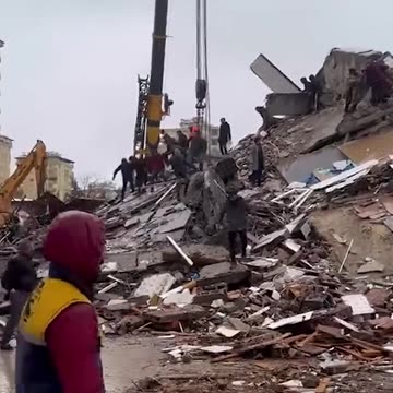 Moment building collapses in Turkey as rescuers continue earthquake searches